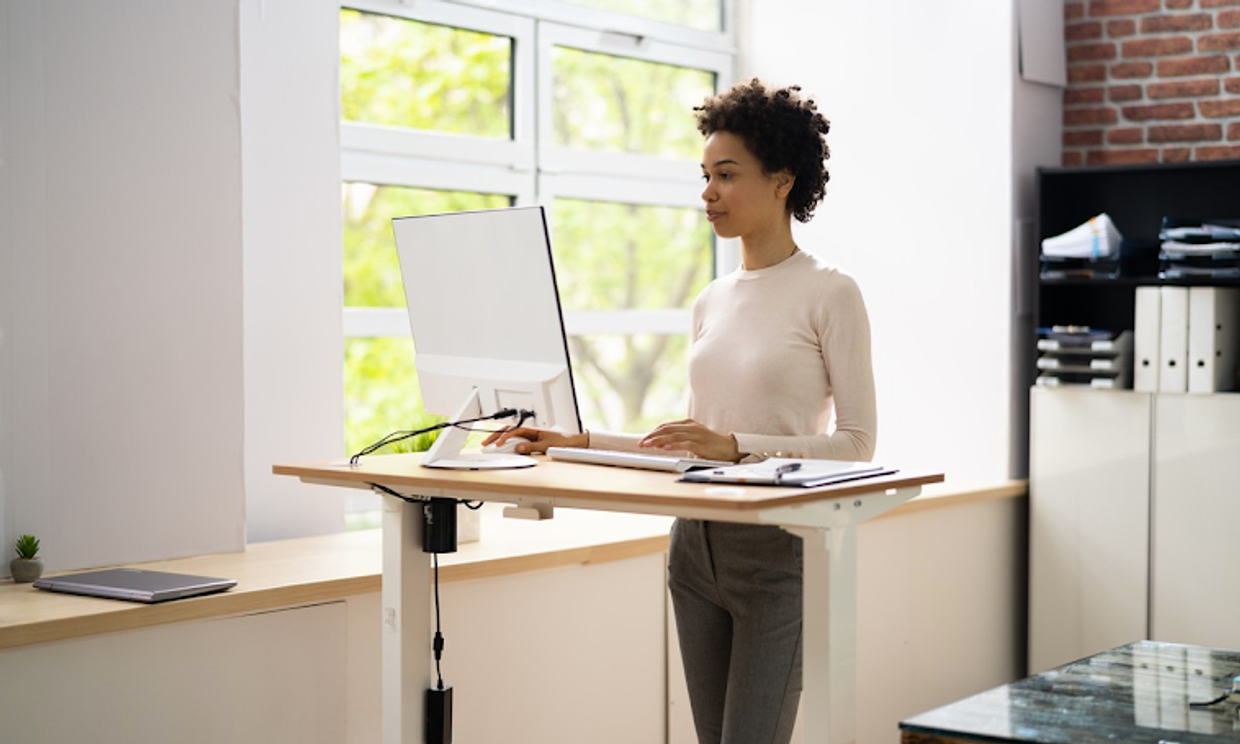 A girl working at a stand up desk